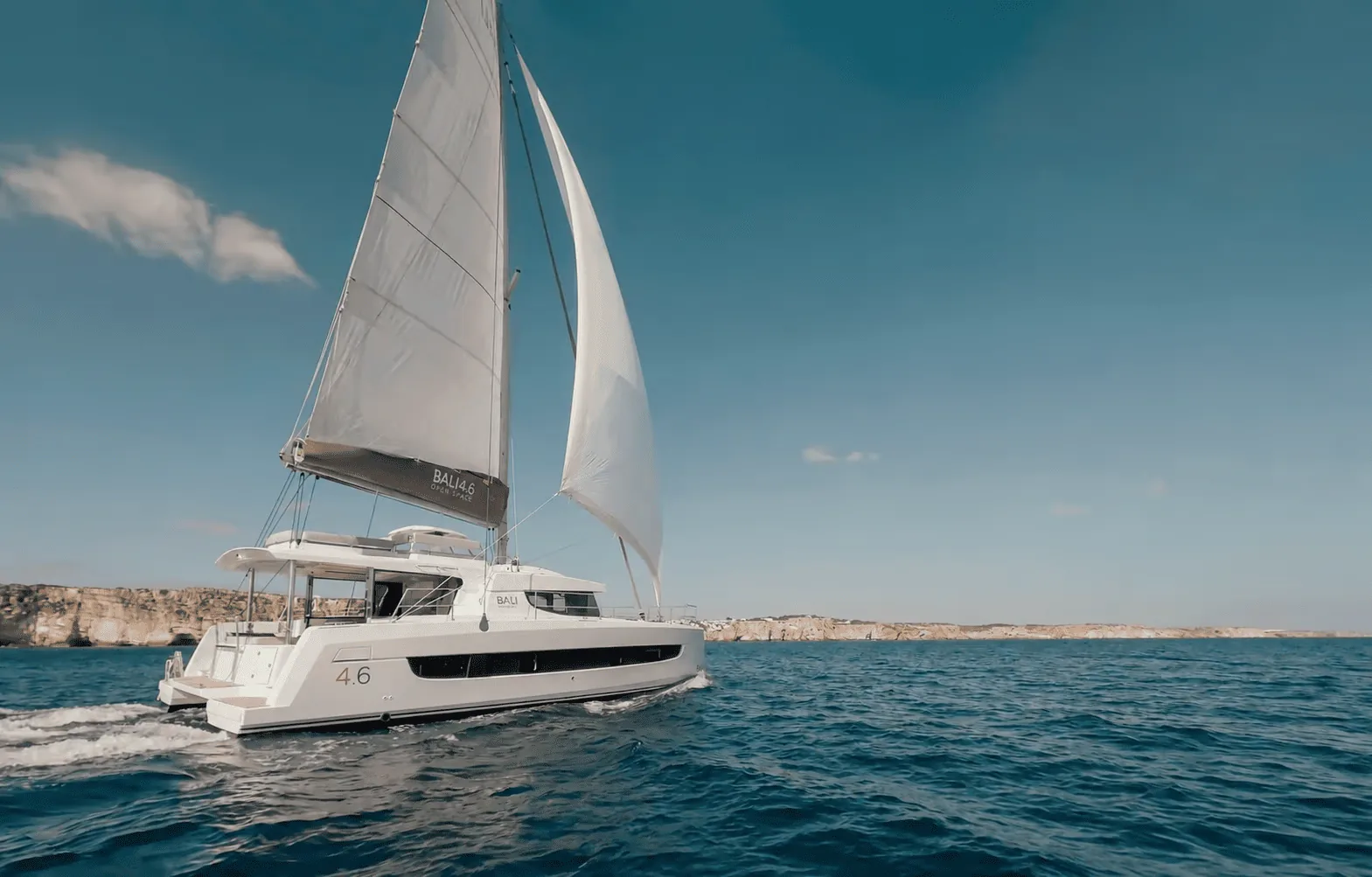 Bali catamaran sailing along limestone cliffs